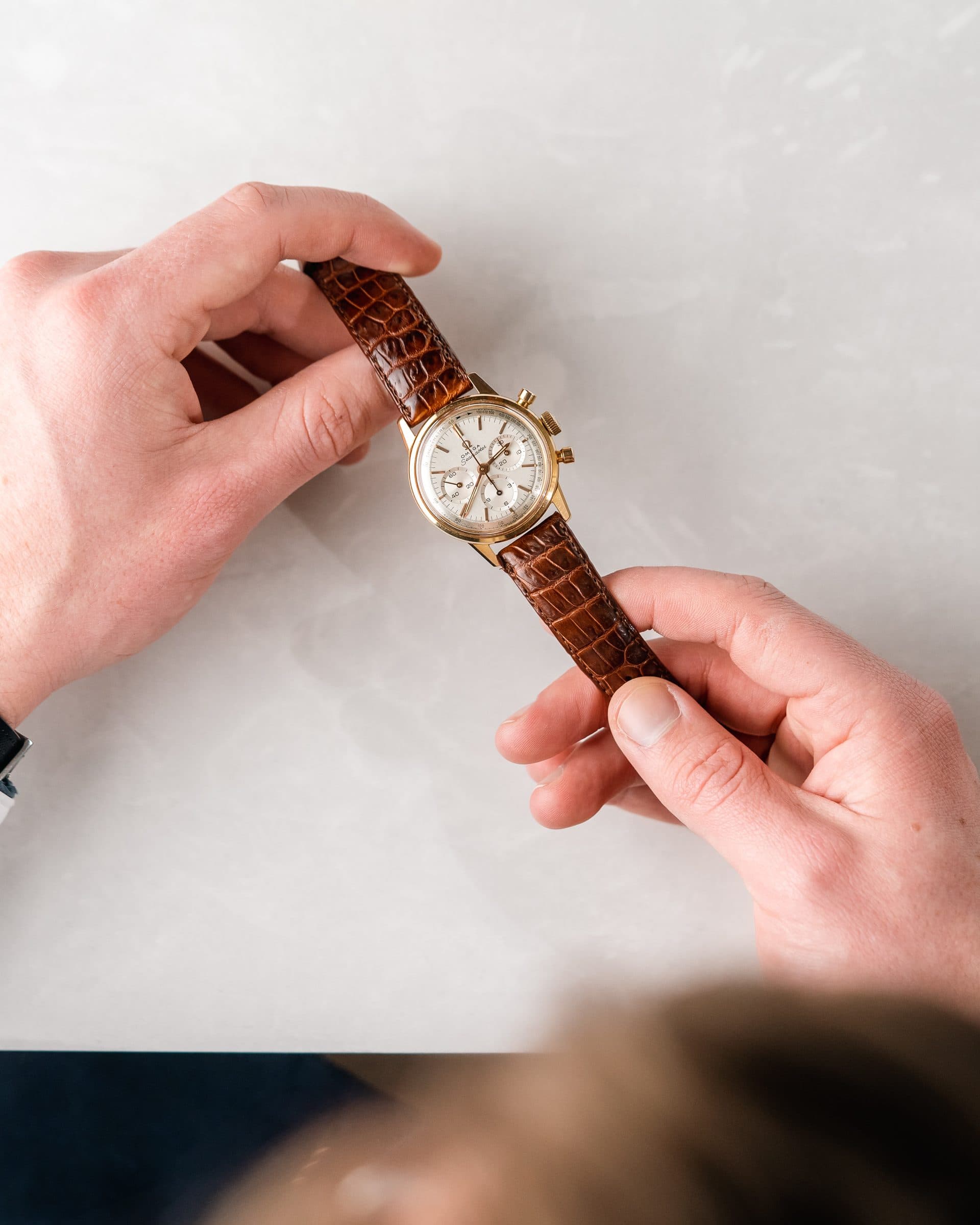 A gold watch in the hand