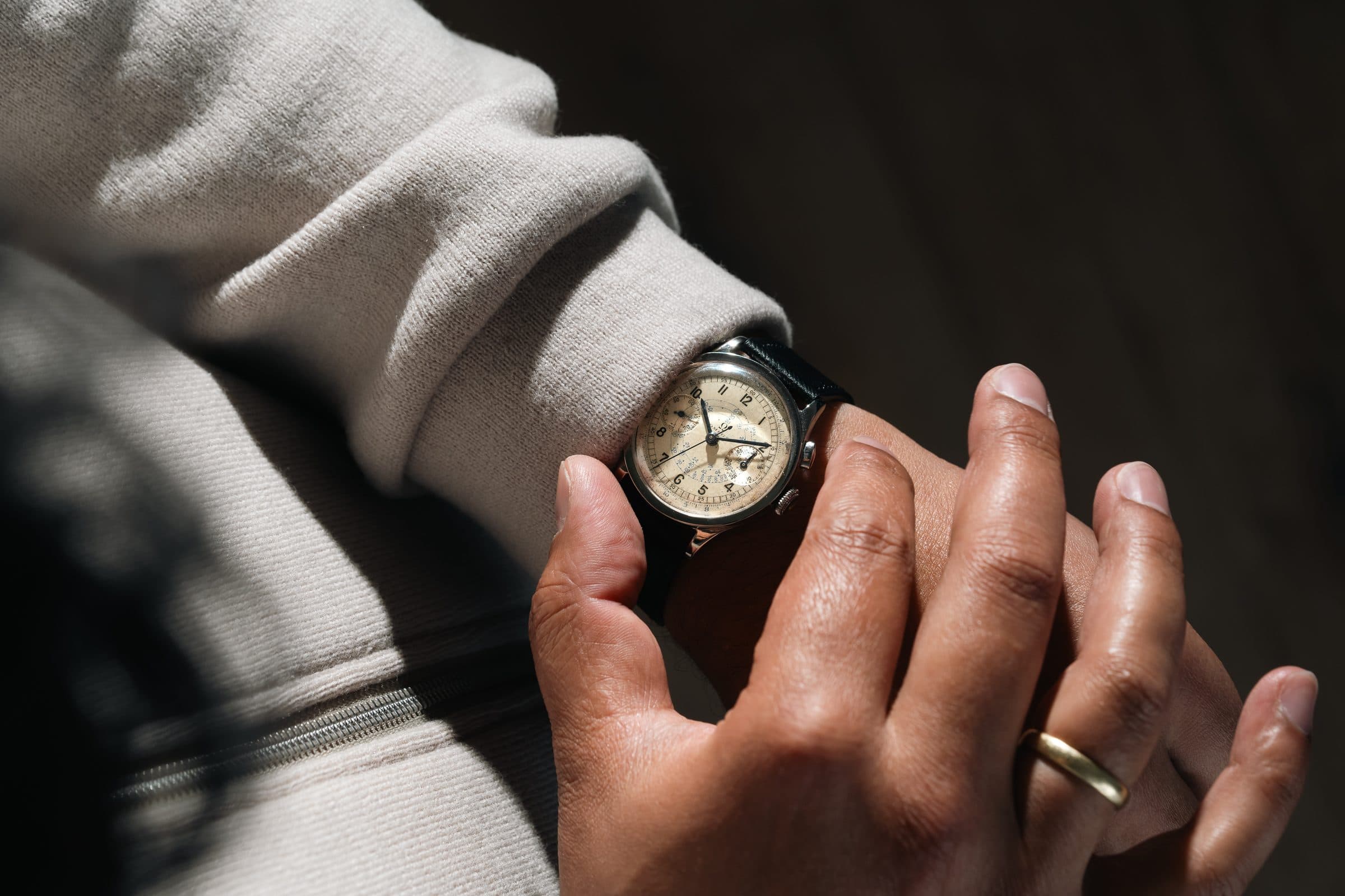 Hands holding a vintage Speedmaster